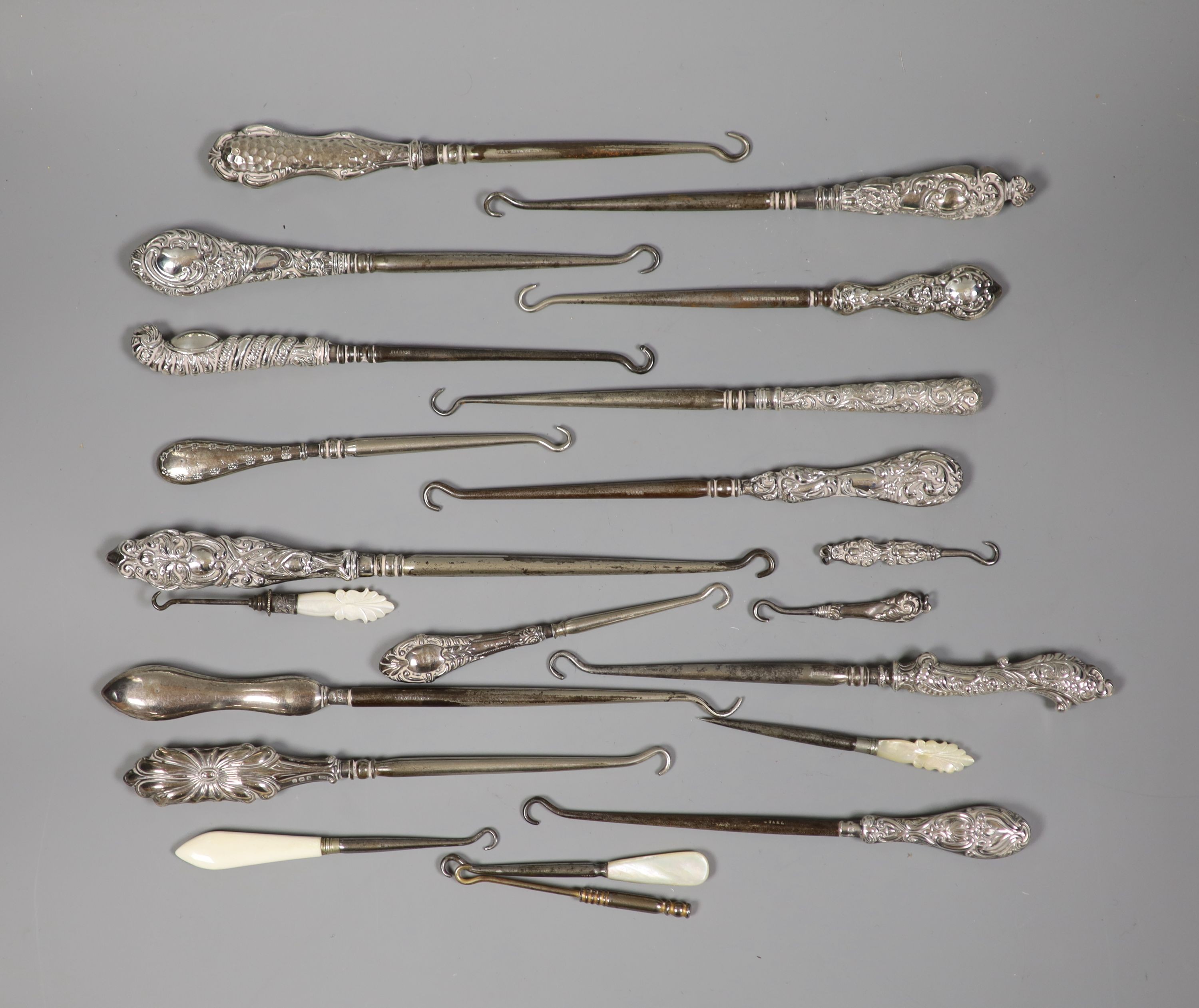 A collection of assorted silver handle button hooks and a nail implement.